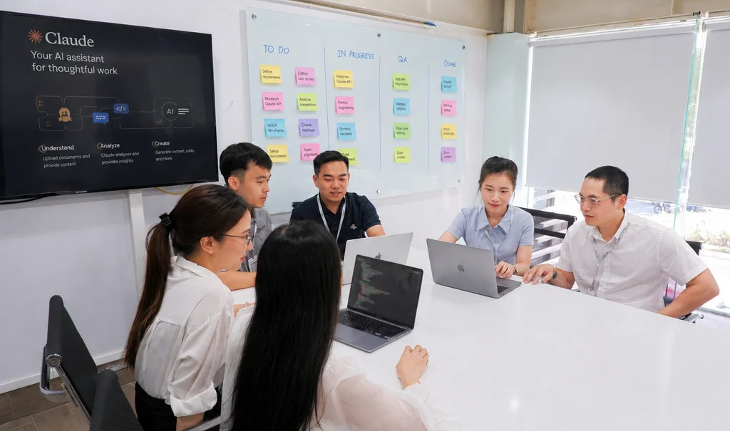 Engineering team collaborating around a product screen
