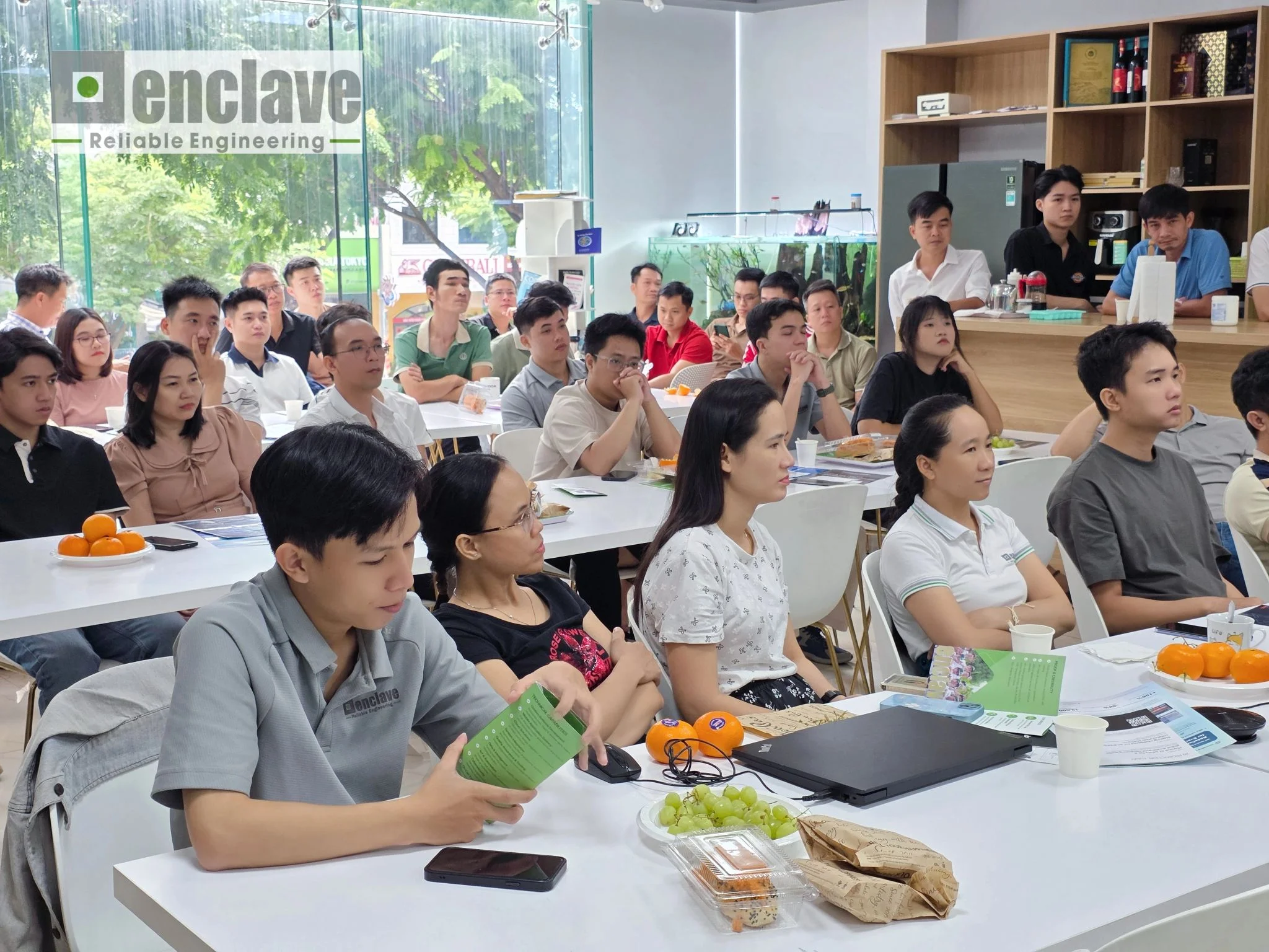 Engineers listening to a knowledge-sharing session during a Coffee Sharing event